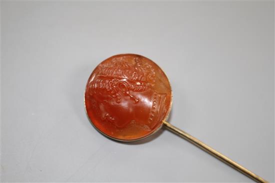 An early 20th century yellow metal and carnelian cameo set stick pin.